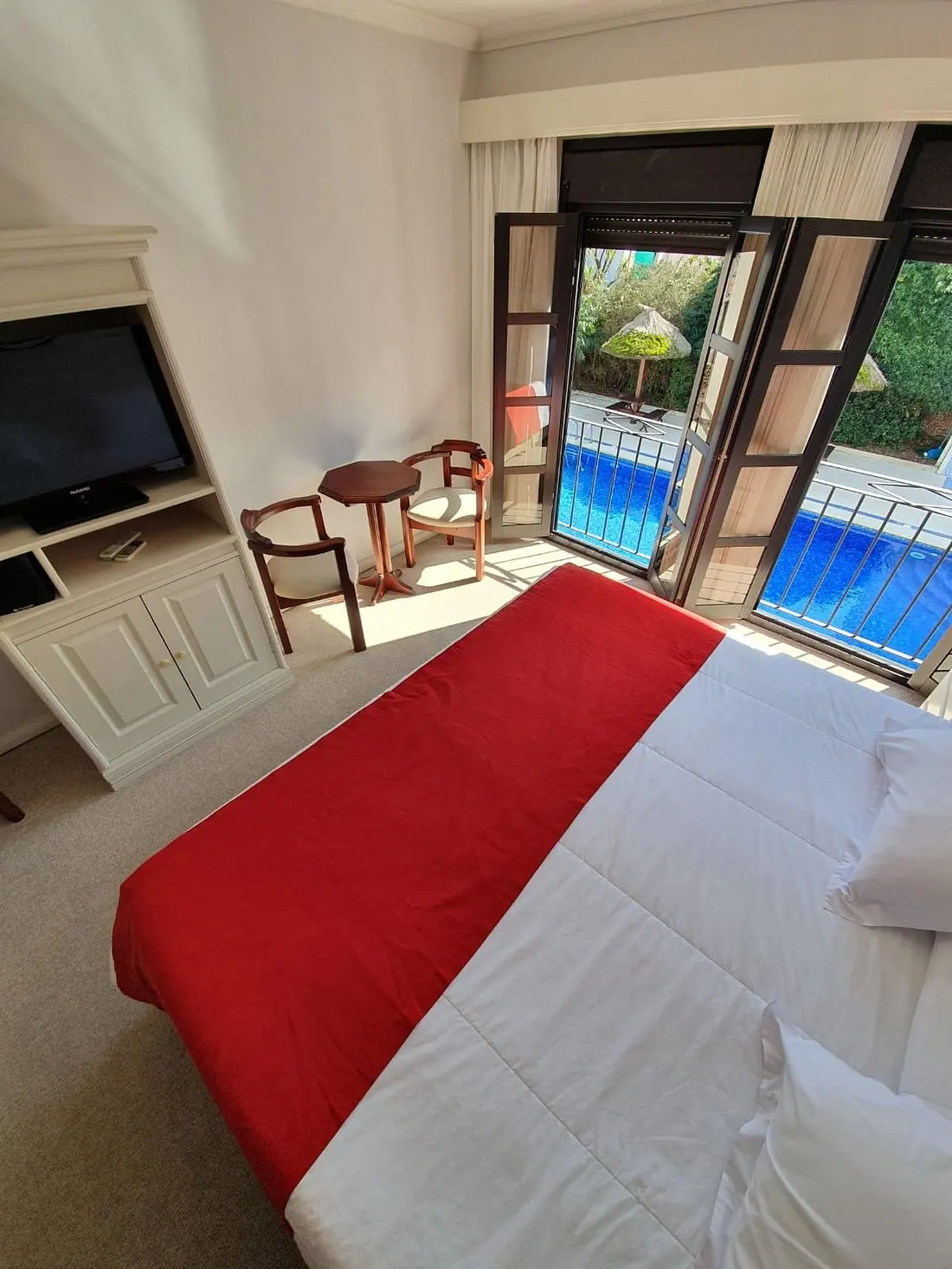 dormitorio_cama_tv_balcon_hotel_italiano.webp